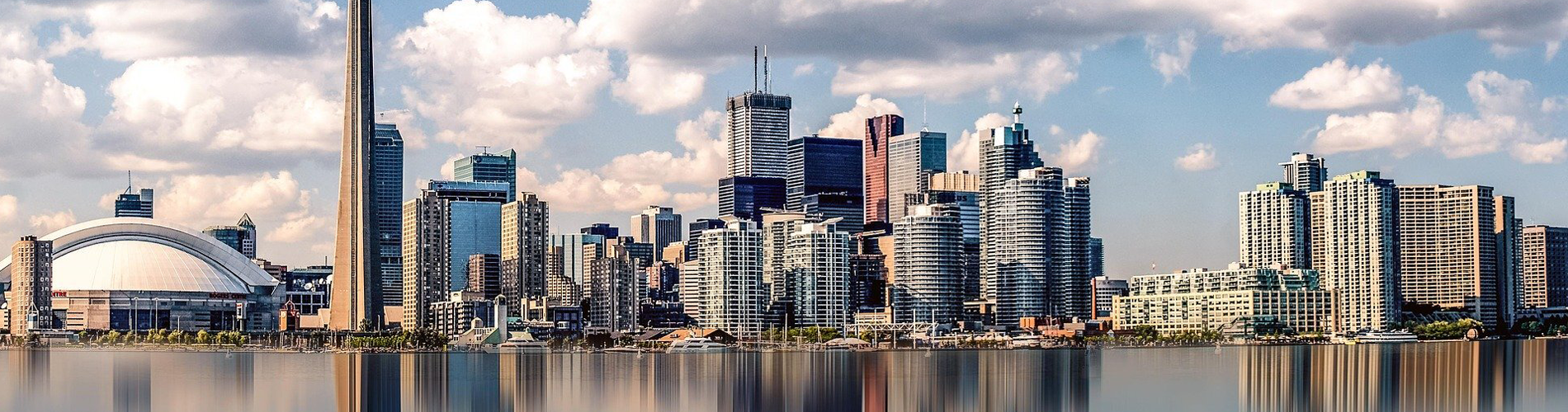 Toronto skyline along the waterfront with the CN Tower reflected in Lake Ontario